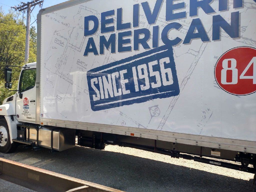84 Lumber box truck with Delivering the American Dream Since 1956 graphic